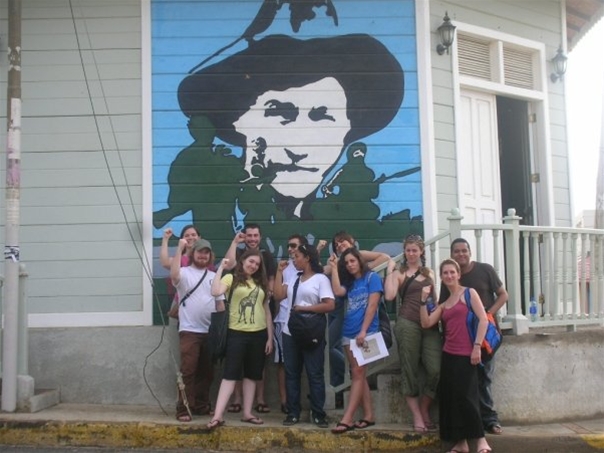 student group in front of mural
