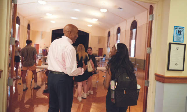 President Eric M. Turner with a student in de Witt Hall. 