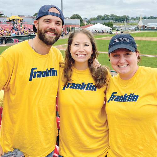 Rachel Craft Howard '09 (right) with Drew Gundloch '08 G'13 (left) and Molly Gundloch '09 (middle) at the Savannah Bananas game in Brockton