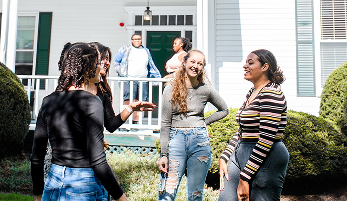 Students outside of Case House at Lasell University