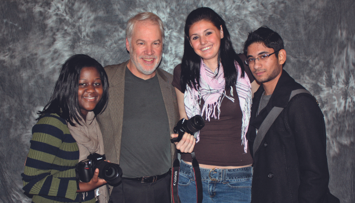 President Michael B. Alexander with members of the Lasell photo club in the 2010s