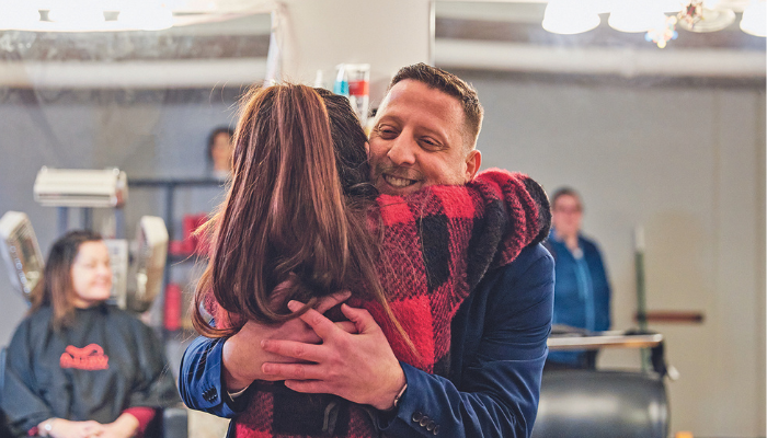 Marlborough Mayor J. Christian Dumais '02 with a customer at Drumais Hair Salon