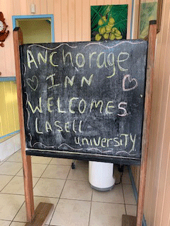 Chalkboard sign says Anchorage Inn welcomes Lasell University