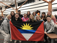 Lasell students holding Antiguan flag