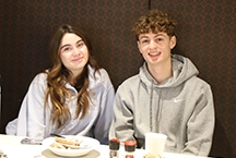 two Lasell students at a dining table