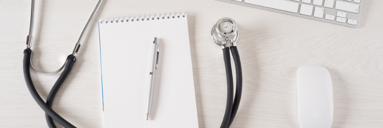 Stethoscope, pen, and pad of paper 