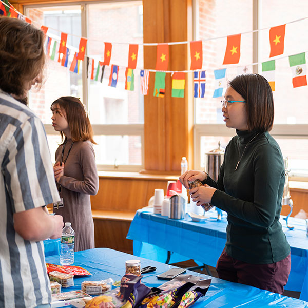 student at table with international flags