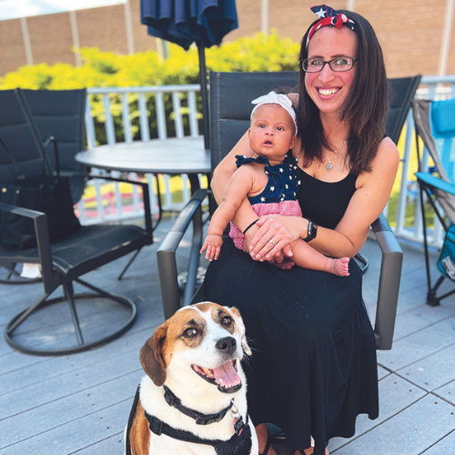 Kayla Perdomo '14 with her daughter and dog. 