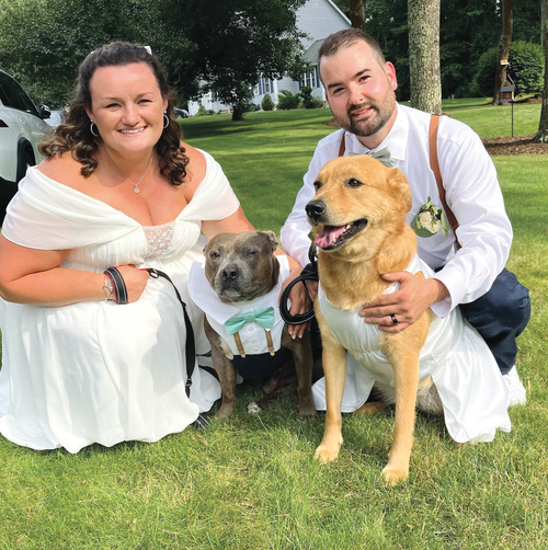 Kaitlyn Quinn '14 G'15 with husband John and dogs Earl and Sugar