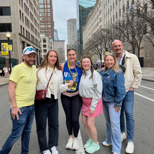 Ashley Doak '15 G'20 (center) with Lasell classmates at the Boston Marathon finish line