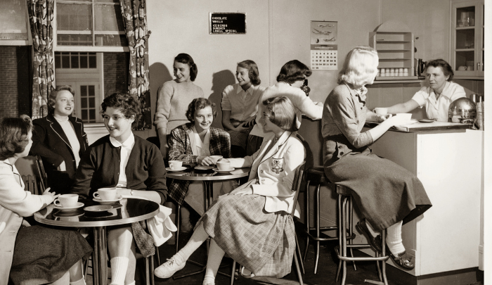 this photo. Please provide short caption for this photo. Lasell Junior College students enjoy a break between classes at The Barn in 1954. Photo courtesy Winslow Archives at Lasell's Brennan Library