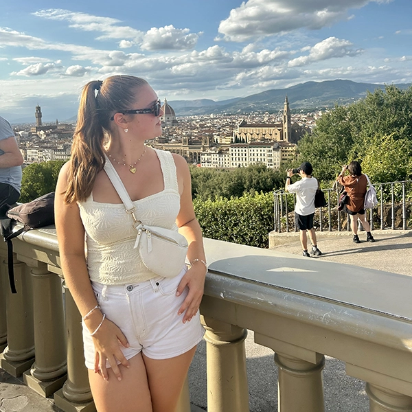 student looking over her shoulder at castle in the distance