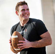 student holding football
