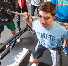 student lifting weights