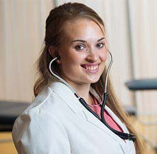 student with stethoscope and lab coat