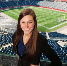 student standing at Gillette Stadium
